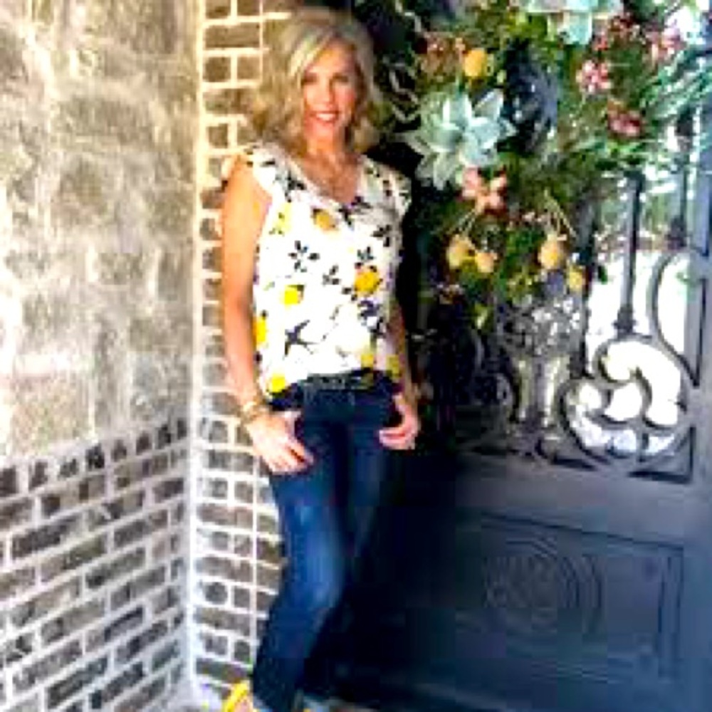 Sleeveless Cabi Top white with black and gold design.